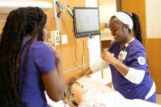 nursing program students working with simulator at UMHB